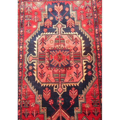 1794 - North west Persian Nahawand rug with a central elongated stepped medallion on a predominantly red gr... 