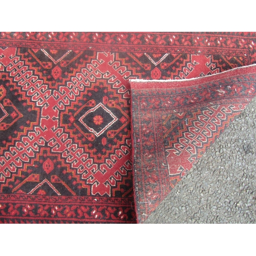 1814 - An old Persian rug with three interlocking hooked medallions 135cm x 75cm approx