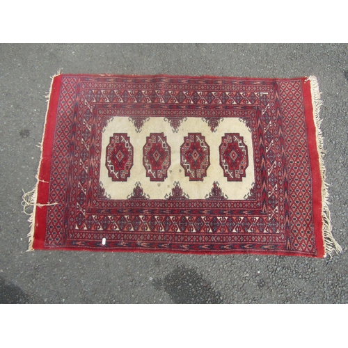 1816 - A small Turkoman rug with a central fawn panel and four medallions, 120cm x 80cm