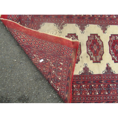 1816 - A small Turkoman rug with a central fawn panel and four medallions, 120cm x 80cm