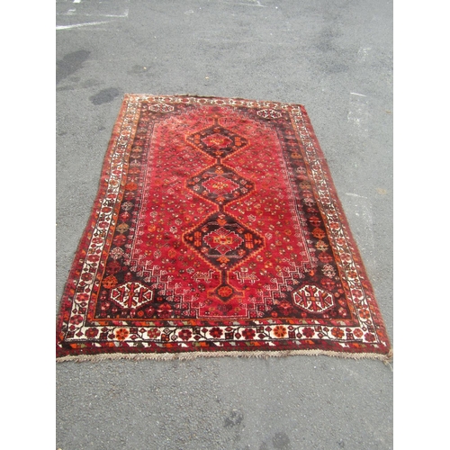 1821 - A large Persian carpet with three interlocking central medallions with stylised birds and flowers on... 