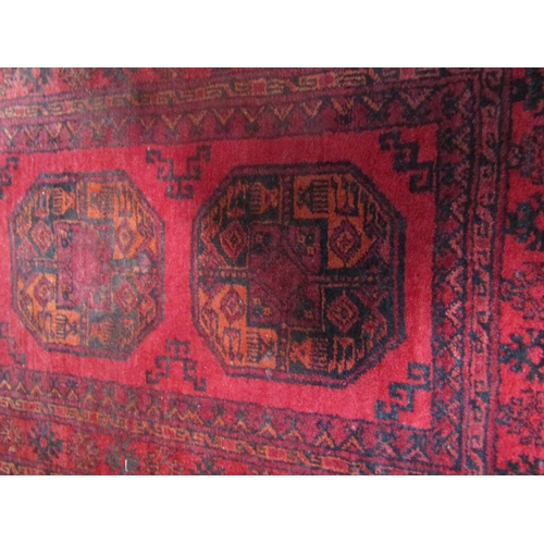 1823 - A small Turkoman rug with two elephant foot on a red ground 120cm x 80cm approx.