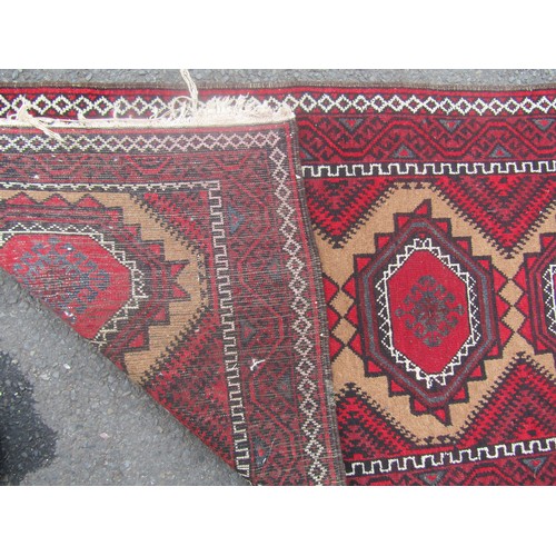 1795 - A Turkoman type carpet with four repeating diamond shaped medallions , 164cm x 83cm approx