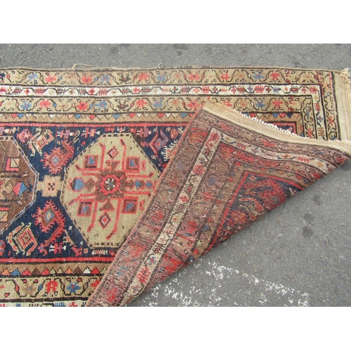 1801 - An Kazak design runner with a row of six gul to the centre 300cm x 95cm approx