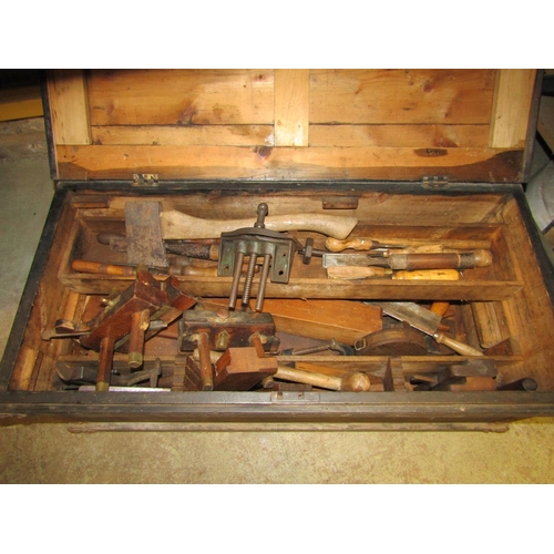 1170 - An antique stained pine carpenters tool chest and contents to include various moulding planes, chise... 