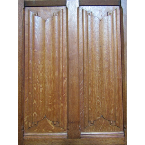 1300 - A large (tall) Gothic revival oak wardrobe of knockdown form enclosed by a pair of full length recta... 