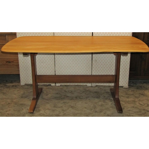 1388 - An Ercol light elm refectory table, the rectangular top with moulded outline raised on waisted suppo... 