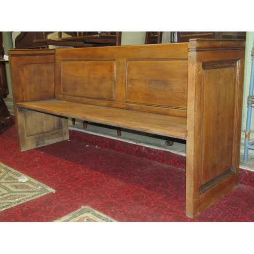 1433 - A vintage oak pew, with fielded panelled ends and plank seat, 174cm long x 51cm deep x 86cm high