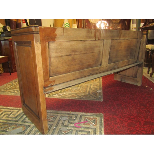 1433 - A vintage oak pew, with fielded panelled ends and plank seat, 174cm long x 51cm deep x 86cm high