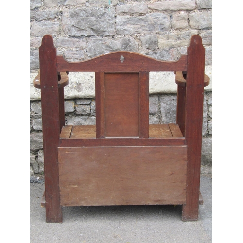 1444 - A 1920s oak hall bench and combined umbrella stand, with hinged box seat, shaped outline and applied... 