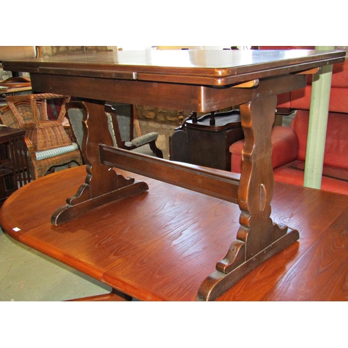 1209 - An Ercol dining room suite a draw leaf refectory table, together with six dining chairs with fleur d... 