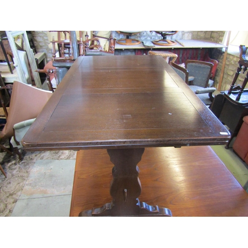 1209 - An Ercol dining room suite a draw leaf refectory table, together with six dining chairs with fleur d... 