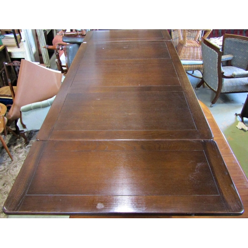 1209 - An Ercol dining room suite a draw leaf refectory table, together with six dining chairs with fleur d... 