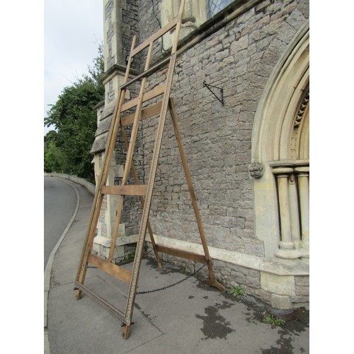 1637 - An outsized oak picture easel with hinged framework, 3.8m tall x 1.2m wide