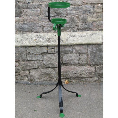 1121 - A wrought iron plant stand with partially twisted stem, raised on splayed tripod base with flattened... 