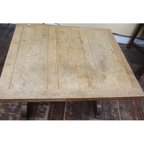 1621a - A arts and crafts style stripped oak draw leaf dining table of rectangular form, raised on square cu... 