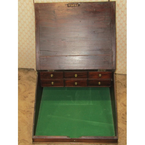 1248A - A Georgian mahogany clerks slope with hinged lid enclosing six small drawers