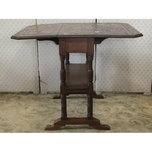 1309 - A late Victorian/Edwardian walnut drop leaf occasional table with decorative carved foliate detail t... 