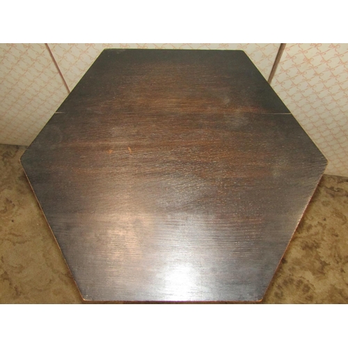 1359a - An arts and crafts oak Moorish style occasional table of hexagonal form of two tiers with turned sup... 