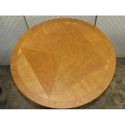 1406a - A contemporary reproduction maple veneered occasional table of circular form, raised on a tapered he... 