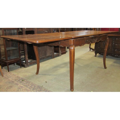 1410 - A continental oak dining room suite comprising a drawleaf table with cube patterned parquet top, a s... 