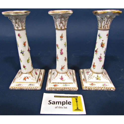 1022 - A 19th century continental porcelain oil lamp frame, the font supported by two cherubs and with flor... 