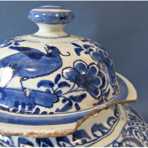 1033 - A large antique English Delft posset pot, late 17th century with loop handles and central spout, tog... 