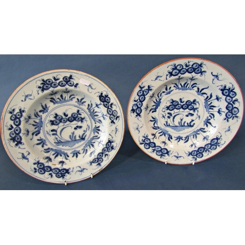 1043 - a pair of late 18th century tin glazed plates in a blue and white colourway with painted abstract fl... 