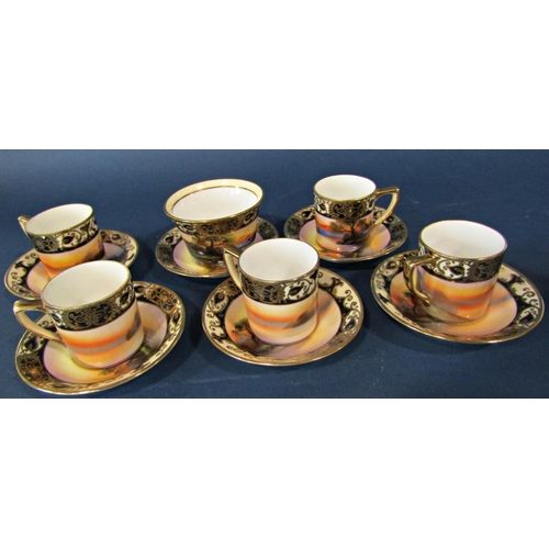 1055 - A Noritake coffee service with hand painted European style detail within repeating blue and gilt bor... 