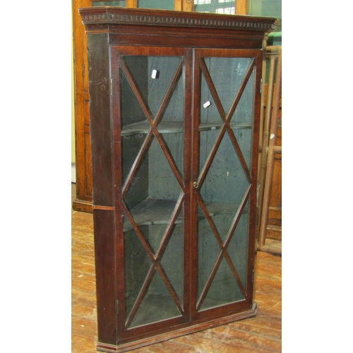 2636 - Georgian mahogany hanging corner cupboard with astragal glazed panelled doors enclosing a fitted and... 