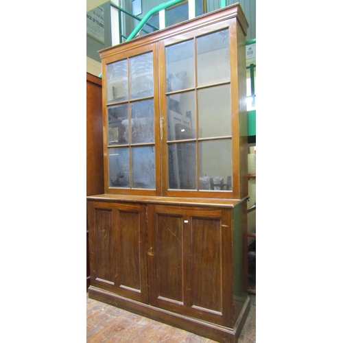 2652 - A Victorian mahogany cabinet the lower section enclosed by panelled doors, the upper section by astr... 