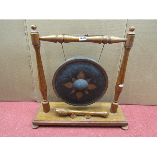 2739 - A house gong, the oak framework supporting a circular metal gong with painted detail, together with ... 