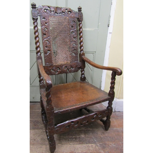 2773 - A Carolean walnut elbow chair with carved and pierced detail, scrolled arms, barley twist and other ... 