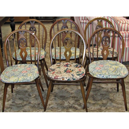 2342 - An Ercol draw leaf refectory table, together with six dining chairs with fleur de lys splats and a f... 