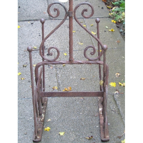 2001 - A weathered ironwork boot stand with S scroll detail and removable loop handle, 125 cm high