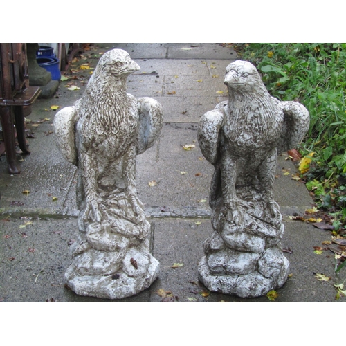 2003 - A pair of cast composition stone garden/pier cap ornaments in the form of eagles perched on rocky ou... 