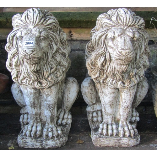 2004 - A pair of cast composition stone garden terrace/pier ornaments in the form of seated lions 57cm high