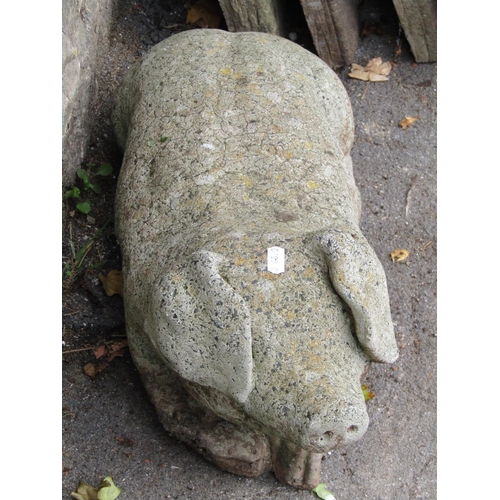 2011 - A weathered cast composition stone garden ornament in the form of a recumbent pig together with two ... 