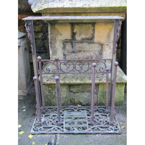 2014 - A contemporary but weathered cast iron boot stand with decorative pierced panels, 64 cm wide x 76 cm... 