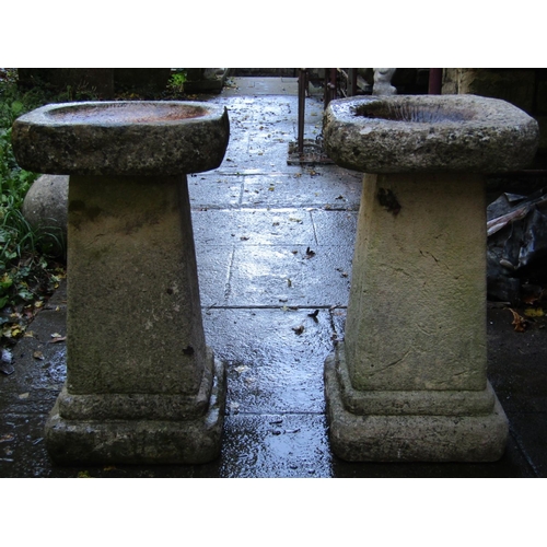 2015 - A pair of weathered cast composition stone two sectional bird baths with square tapered and stepped ... 