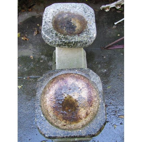 2015 - A pair of weathered cast composition stone two sectional bird baths with square tapered and stepped ... 