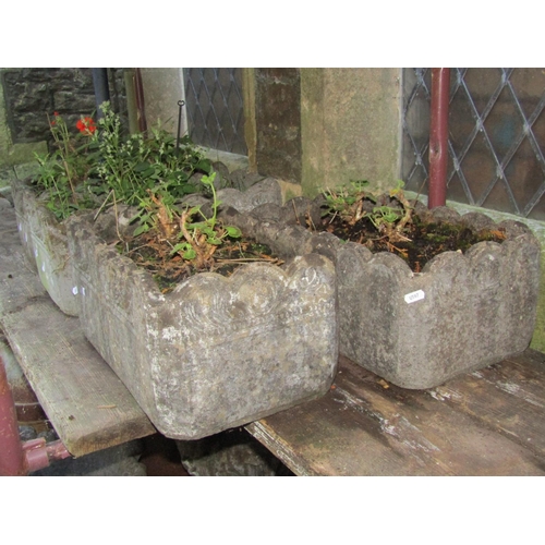 2023 - A set of four weathered cast composition stone garden planters of rectangular form with repeating th... 