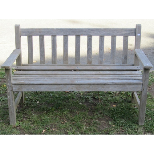 2028 - A Jonelle weathered Burma teak two seat garden bench with slatted seat and back, together with a wea... 