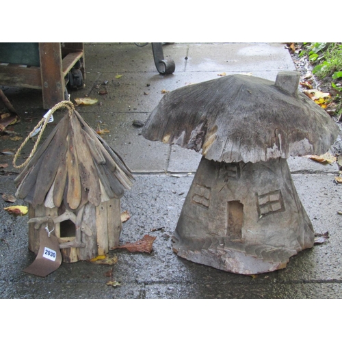 2030 - A small novel rustic hanging bird box, 32 cm high, together with a small carved toadstool shaped fai... 