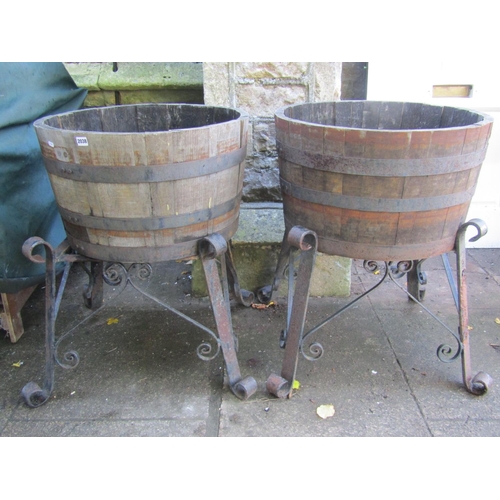 2038 - A pair of coopered oak and steel banded half barrel planters labelled Allsa, raised on scrolled iron... 