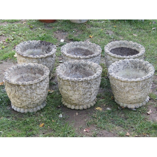 2044 - A set of six weathered cast composition stone garden planters of circular form with repeating acorn ... 