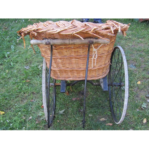 2052 - A Victorian bath chair with sprung seat, wire spoke wheels, hard rubber tyres (basket seat for recom... 