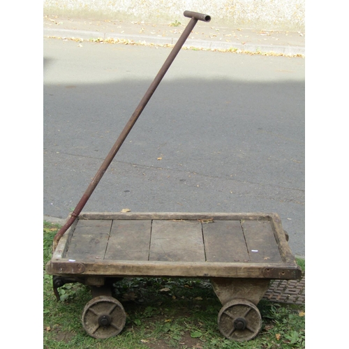 2057 - A useful vintage platform trolley/hand cart with T shaped tubular steel handle, timber bed, 4 iron w... 