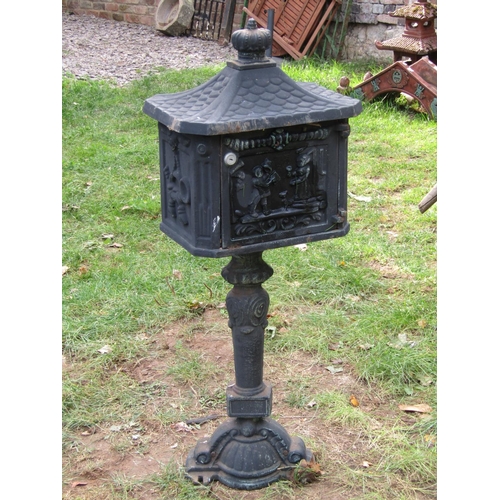 2061 - A reproduction cast iron freestanding post box with simulated tiled roof, crown finial, 1 metre high... 