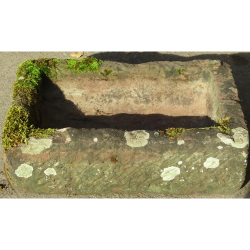 2081 - A weathered natural stone trough of rectangular form, 64cm long x 45cm wide x 18cm deep